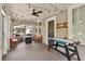 Inviting front porch with string lights, furniture, and air hockey for relaxation at 501 Washington Ave, Eustis, FL 32726
