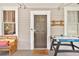 Cozy front porch featuring comfortable seating and an air hockey table near front door at 501 Washington Ave, Eustis, FL 32726