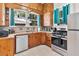 This kitchen has wooden cabinets, stainless steel appliances, tile backsplash, and plenty of natural light at 501 Washington Ave, Eustis, FL 32726