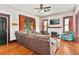 Comfortable living room showcasing hardwood floors, cozy couch, and bright natural light at 501 Washington Ave, Eustis, FL 32726