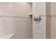 This modern shower has tiled walls, a built-in niche, and a sleek dispenser for shampoo and conditioner at 501 Washington Ave, Eustis, FL 32726