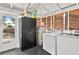 Utility room features new washer and dryer units, hot water tank, and storage space at 501 Washington Ave, Eustis, FL 32726
