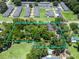 Aerial view of a home surrounded by lush greenery within a defined property line at 504 Gilliam St, Wildwood, FL 34785