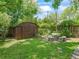 Relaxing backyard view of garden shed and stone patio set at 504 Gilliam St, Wildwood, FL 34785