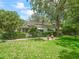 Exterior shot of the house with a well-maintained lawn and lovely landscaping at 504 Gilliam St, Wildwood, FL 34785