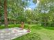 Large backyard with stone patio and green hoses at 504 Gilliam St, Wildwood, FL 34785