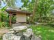 Private, covered patio with stone mosaic table and stone benches at 504 Gilliam St, Wildwood, FL 34785