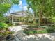Quaint home displaying well-maintained landscaping, a curved walkway, and a serene outdoor setting at 504 Gilliam St, Wildwood, FL 34785