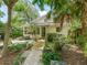 Charming home showcasing a landscaped front yard with a wooden ramp, inviting curb appeal, and lush greenery at 504 Gilliam St, Wildwood, FL 34785