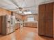 Open kitchen with stainless steel appliances, wood cabinets, and wood flooring at 504 Gilliam St, Wildwood, FL 34785
