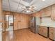 Spacious kitchen with stainless steel refrigerator, ample wood cabinetry, and an adjacent dining area at 504 Gilliam St, Wildwood, FL 34785
