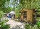 Outdoor outbuilding and workshop, surrounded by lush landscaping and greenery at 504 Gilliam St, Wildwood, FL 34785