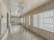 Enclosed porch with wood paneled walls and ceiling, tile floors and lots of natural light at 504 Gilliam St, Wildwood, FL 34785