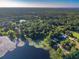 Beautiful aerial view of homes surrounded by a lush green forest and a calm lake at 54544 Buckhorn Rd, Astor, FL 32102