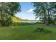Scenic backyard with lush grass, a distant lake view, and mature trees at 54544 Buckhorn Rd, Astor, FL 32102