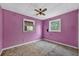 Small bedroom featuring pink walls, a ceiling fan, and two windows providing natural light at 54544 Buckhorn Rd, Astor, FL 32102