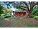 Red home with lush trees, offering a tranquil atmosphere at 54544 Buckhorn Rd, Astor, FL 32102