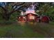 Charming single-story home featuring mature landscaping and a cozy covered porch at 54544 Buckhorn Rd, Astor, FL 32102
