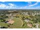 Overhead view featuring community baseball field, roads and landscaping, showcasing the neighborhood's layout at 5715 Illumination Ln, Leesburg, FL 34748