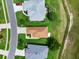 Drone shot of a single-Gathering home showing the roofline, driveway, and lawn in a well-maintained community at 5715 Illumination Ln, Leesburg, FL 34748