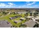 Aerial view showing bocce and shuffleboard courts in a beautifully landscaped community at 5715 Illumination Ln, Leesburg, FL 34748
