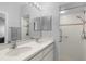 Bathroom featuring double vanity with white cabinets and tiled walk-in shower at 5715 Illumination Ln, Leesburg, FL 34748