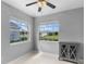 Bedroom featuring neutral paint, two windows, and gray cabinet at 5715 Illumination Ln, Leesburg, FL 34748