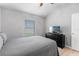 Cozy bedroom featuring a serene atmosphere with a window and a television on top of a dresser at 5715 Illumination Ln, Leesburg, FL 34748