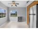 Dining room featuring neutral paint, two windows, and stainless steel refrigerator at 5715 Illumination Ln, Leesburg, FL 34748