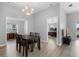 Bright dining area with modern chandelier, hardwood floors, and views to bedroom and Gathering room at 5715 Illumination Ln, Leesburg, FL 34748