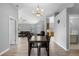 Open-concept dining area with hardwood floors, seamlessly connecting to the living room and kitchen at 5715 Illumination Ln, Leesburg, FL 34748