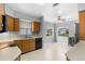 Well-lit kitchen with oak cabinets, functional appliances, and a bright breakfast nook at 5715 Illumination Ln, Leesburg, FL 34748