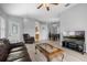 Open concept living area with hardwood floors, a ceiling fan, and seamless flow to dining at 5715 Illumination Ln, Leesburg, FL 34748