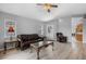 Comfortable living room showcasing sleek floors, a ceiling fan, and ample natural light at 5715 Illumination Ln, Leesburg, FL 34748