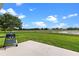 Open patio boasting a grill and scenic lake views, perfect for outdoor relaxation at 5715 Illumination Ln, Leesburg, FL 34748