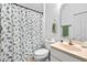 Standard bathroom with beige vanity, toilet and patterned shower curtain at 5740 Bounty Cir, Tavares, FL 32778