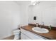 Neutral half bath featuring a sink, toilet and a framed mirror at 5740 Bounty Cir, Tavares, FL 32778
