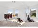 Spacious bedroom featuring three windows and wood flooring at 5740 Bounty Cir, Tavares, FL 32778
