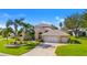 Charming house featuring a three-car garage and a well-manicured lawn at 5740 Bounty Cir, Tavares, FL 32778