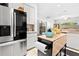 Well-lit kitchen featuring stainless steel appliances, white cabinets, and functional island at 5740 Bounty Cir, Tavares, FL 32778
