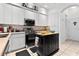 Modern kitchen with sleek appliances, light-colored cabinets, and island at 5740 Bounty Cir, Tavares, FL 32778