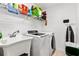 Bright laundry room with washer, dryer, and utility sink at 5740 Bounty Cir, Tavares, FL 32778