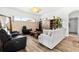 Cozy living room with modern furnishings, wood-look flooring, and natural light at 5740 Bounty Cir, Tavares, FL 32778
