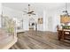 Bright living room showcasing wood floors, ceiling fan, staircase, and arched doorways for an open floor plan at 5740 Bounty Cir, Tavares, FL 32778