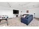 Spacious carpeted living room offering a large tv and comfortable seating at 5740 Bounty Cir, Tavares, FL 32778