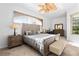 Serene main bedroom featuring a comfortable bed, soft carpet, and plenty of natural light at 5740 Bounty Cir, Tavares, FL 32778