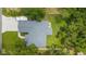 Aerial view showcases the home's roof and sprawling backyard with lush greenery and fencing at 8160 Se 164Th Pl, Summerfield, FL 34491