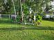 Landscaped backyard features tropical plants and decorations and a lush green lawn at 8160 Se 164Th Pl, Summerfield, FL 34491