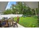 Lush backyard featuring a dining area, landscaping, and a privacy fence at 8160 Se 164Th Pl, Summerfield, FL 34491