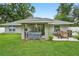 A covered patio features a hot tub, seating, and grill, perfect for outdoor entertaining at 8160 Se 164Th Pl, Summerfield, FL 34491